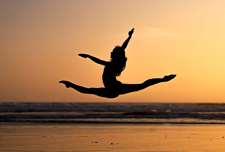 silhouette photo of woman splitting on air thumbnail