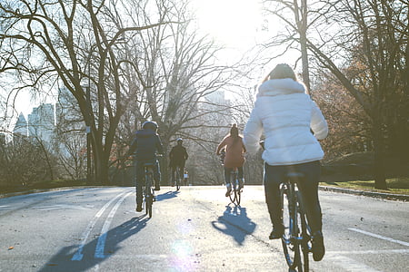 four person ride on bicycles during daytime thumbnail