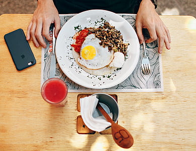 Fried Egg With Plain Rice on White Plate Beside Stainless Steel Fork With Clear Drinking Glass on Top Table thumbnail