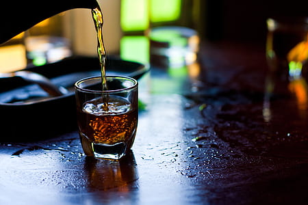 beverage container pouring liquid on shot glass thumbnail
