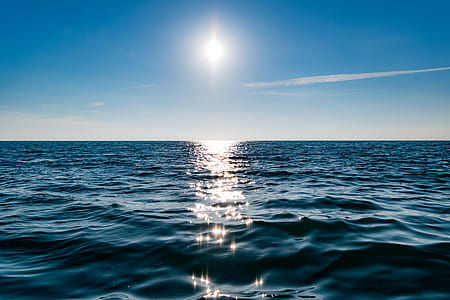 blue body of water under blue sunny sky thumbnail