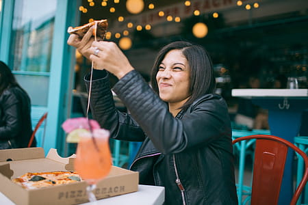 Photo of Woman Holding Pizza thumbnail