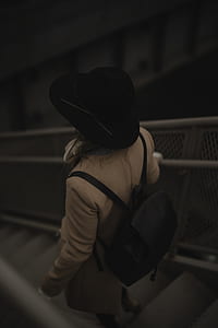 selective focus photography of woman going downstairs thumbnail