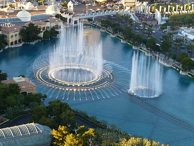 aerial photography of dancing water on body of water between city thumbnail