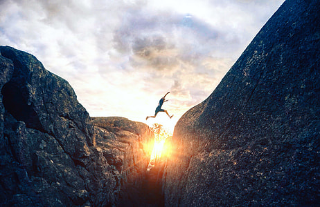 person leap on another hill during sunset thumbnail