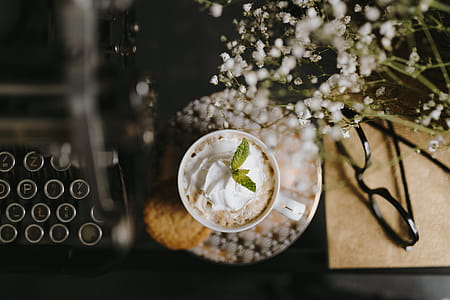Coffee in a decorative cup with a golden ornament thumbnail