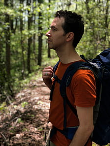 Man in Red Crew-neck Shirt Carrying Blue Hiking Backpack thumbnail