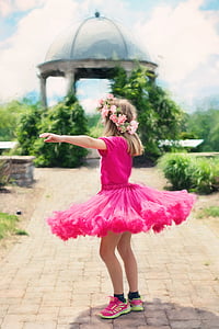 girl wearing pink tutu dress standing facing on green leaf plant selective focus photograph thumbnail