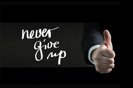 human hand with never give up text overlay thumbnail