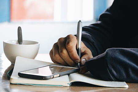 person writing on notebook thumbnail