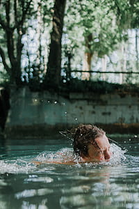person swimming in body of water thumbnail