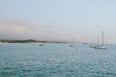 white sailing boat on body of water thumbnail