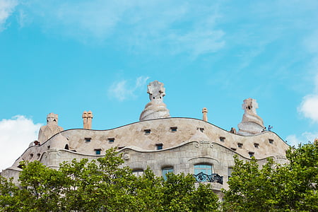 low angle photo of gray concrete building under blue sky thumbnail