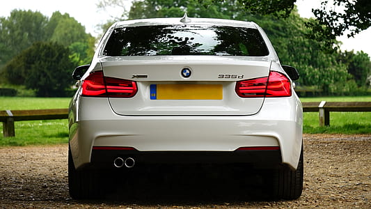 white BMW car near trees and bench thumbnail