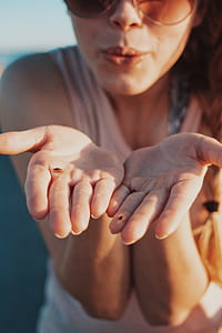 women's holding bug on palm during daytime thumbnail