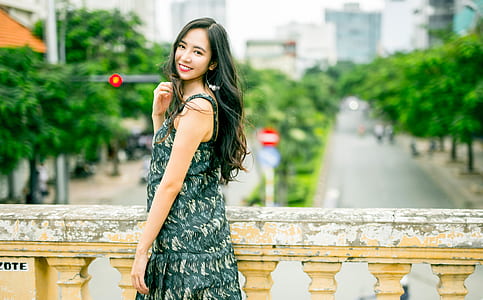 woman wearing dress standing on bridge thumbnail