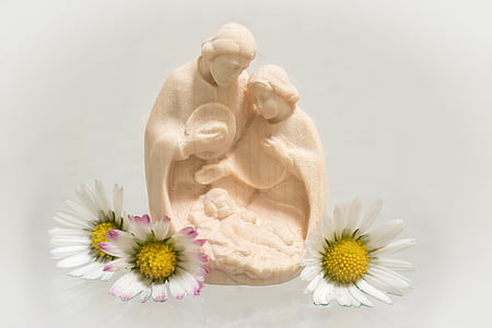 nativity figurine and white petaled flower thumbnail