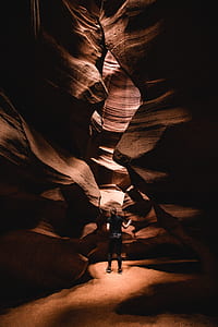 woman standing between cave rocks thumbnail