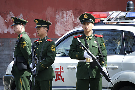 three man standing beside white police car thumbnail