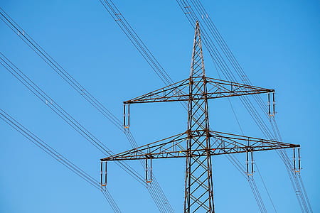 grey transmission tower under blue sky thumbnail