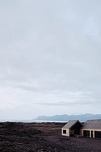 white and gray wooden house near body of water thumbnail