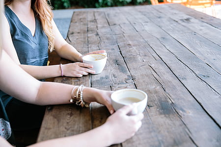people having tea on brown wooden table thumbnail