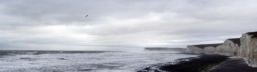 photography of body of water under cloudy sky during daytime thumbnail