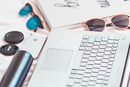 black laptop computer keyboard near brown sunglasses thumbnail