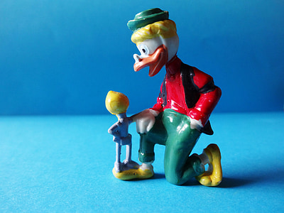 duck wearing red suit and green pants figurine thumbnail