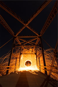 steel wool photography of light on bridge at nighttime thumbnail