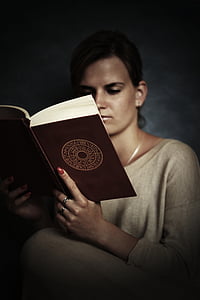 woman reading brown book thumbnail