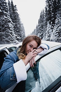 woman standing in front of her car while leaning on door thumbnail