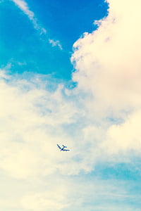 plane flying under white cloudy sky during daytime thumbnail
