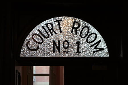 Sign above the door as a person enters the courtroom. thumbnail