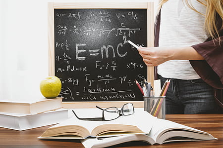 Woman Illustrating Albert Einstein Formula thumbnail