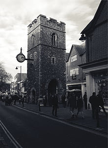 group of people walking beside tower near sidewalk thumbnail