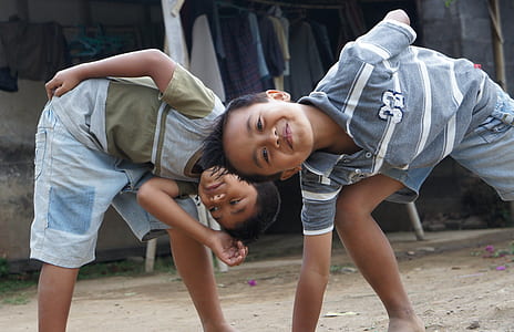 two boy's wearing blue polo shirt and gray t-shirt thumbnail