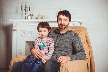 man and girl sitting on sofa chaier thumbnail