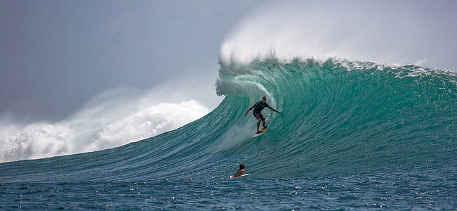 portrait photography of person surfing on wave barrels thumbnail