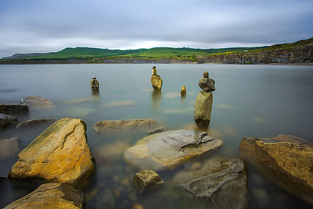 photo of brown rocks near water thumbnail