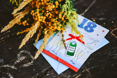Yellow flowers with miscellaneous items on wooden floor thumbnail