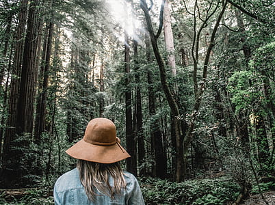 woman wearing blue shirt wearing hat in forest thumbnail