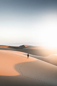 man standing in the middle of desert thumbnail