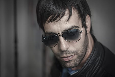 man wearing aviator sunglasses looking at camera thumbnail