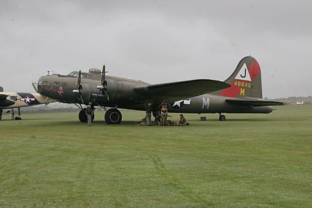 black airplane parked on grass field thumbnail
