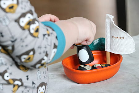 toddler's playing orange sail boat toy thumbnail