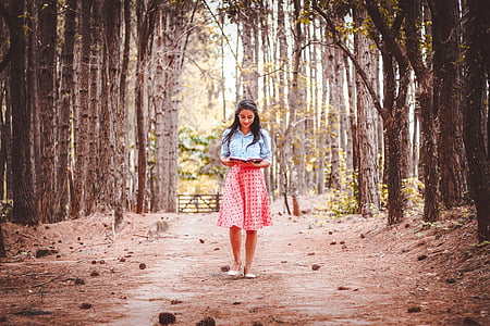 woman standing on forest during daytime thumbnail