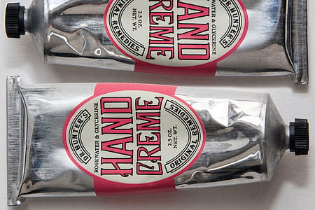 two silver Hand Creme collapsible tubes thumbnail
