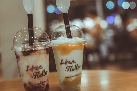 Two Liferia Hello Coffee Drinks on Brown Wooden Table thumbnail
