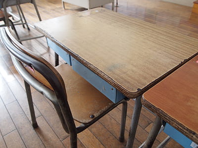 rectangular brown wooden table beside armless chair thumbnail